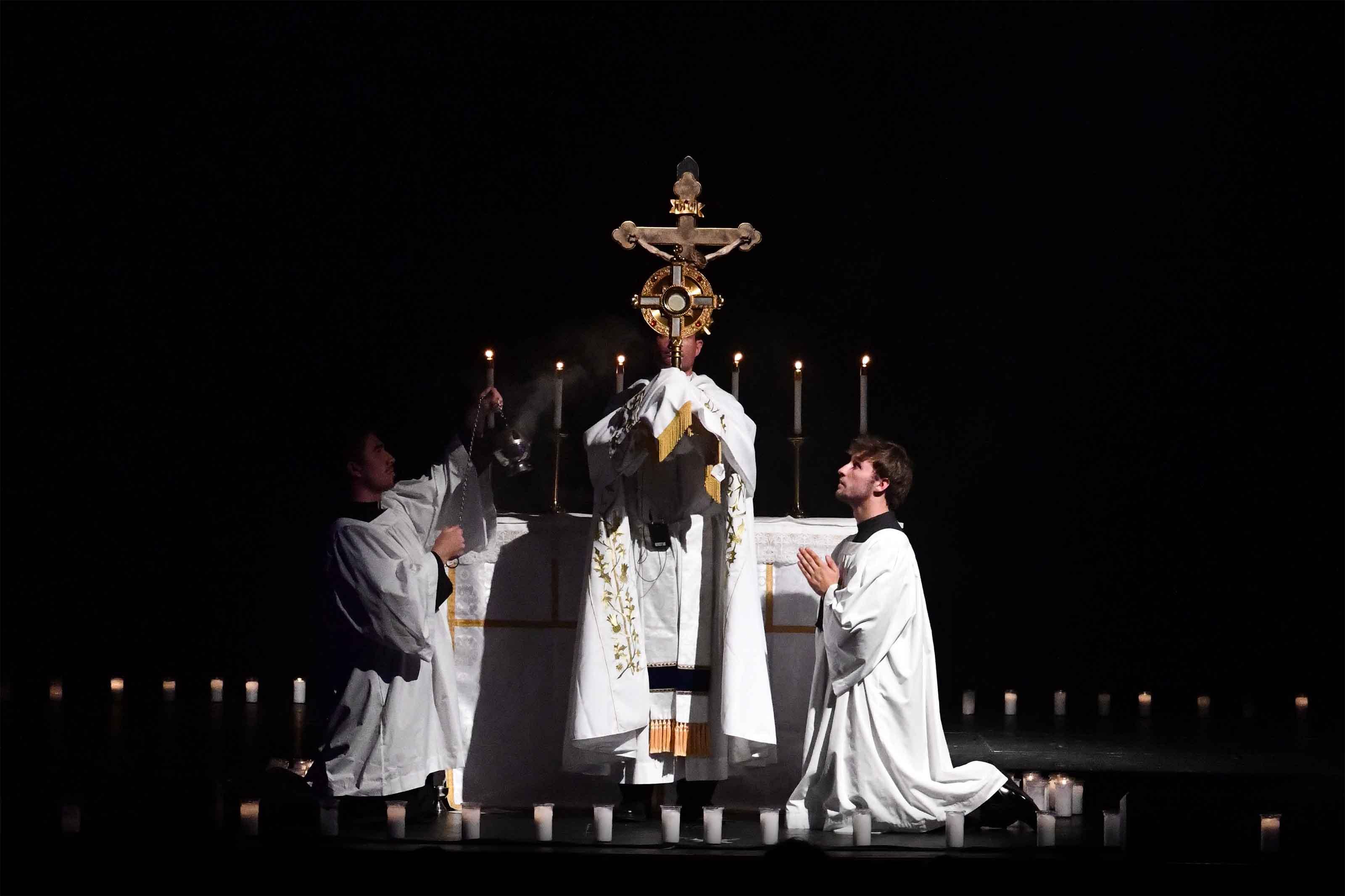 A priest elevates the monstrance during Eucharistic adoration